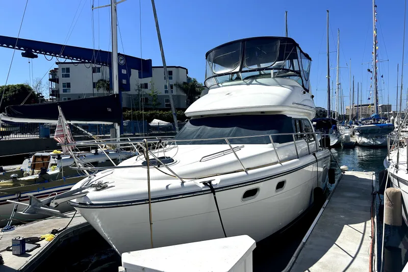 Slide: The Image of 2002 Bayliner 3488 Avanti yacht docked at a marina under clear blue skies. - 35