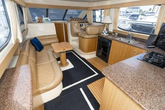 Slide: The Image of Luxurious interior of 2002 Bayliner 3488 Avanti yacht with leather seating and kitchenette. - 4