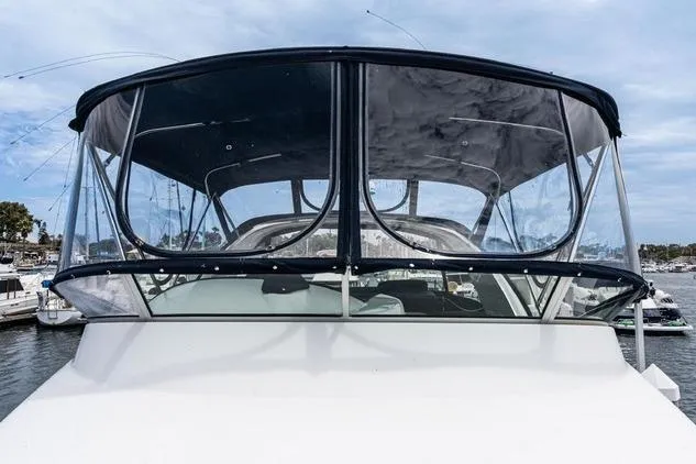 Slide: The Image of 2002 Bayliner 3488 Avanti boat with enclosed cockpit, docked at marina. - 6