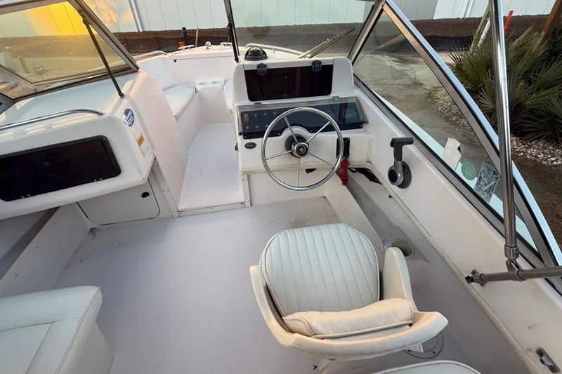 Slide: The Image of 1997 Grady-White Tournament 192 boat interior with steering wheel and seating. - 15