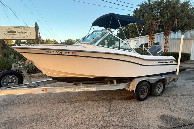 Slide: The Image of 1997 Grady-White Tournament 192 boat on trailer, parked outdoors with palm trees. - 6