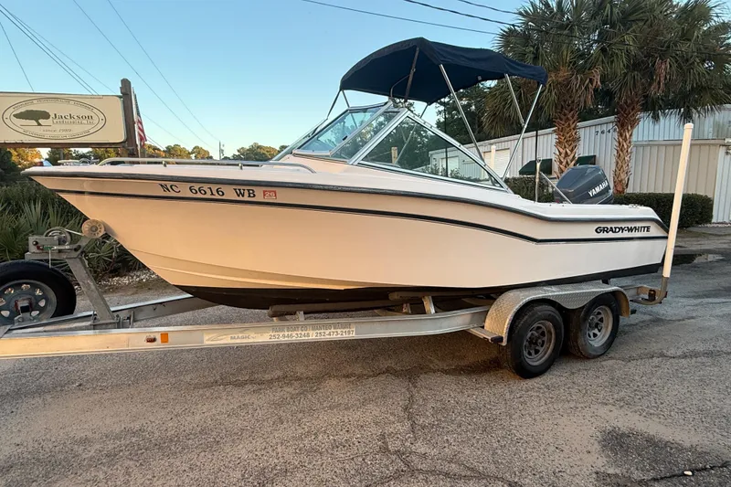 Slide: The Image of 1997 Grady-White Tournament 192 boat on trailer, parked outdoors with palm trees. - 7
