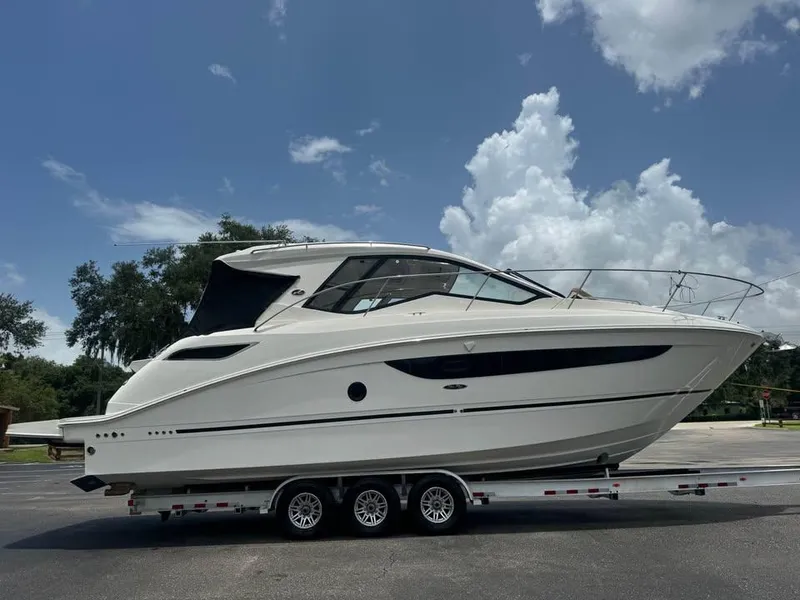 Slide: The Image of 2017 Sea Ray Sundancer 350 Coupe on trailer under blue sky. - 1