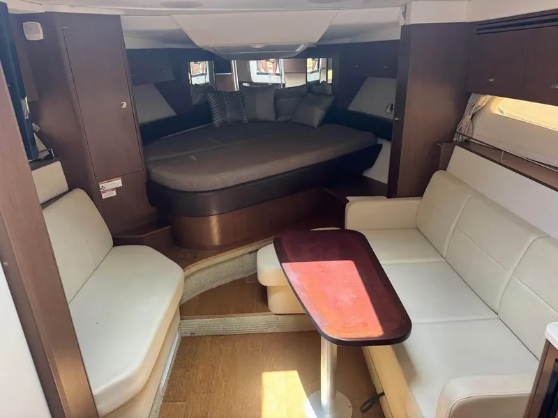 Slide: The Image of Interior of 2017 Sea Ray Sundancer 350 Coupe with cozy seating and bed. - 14