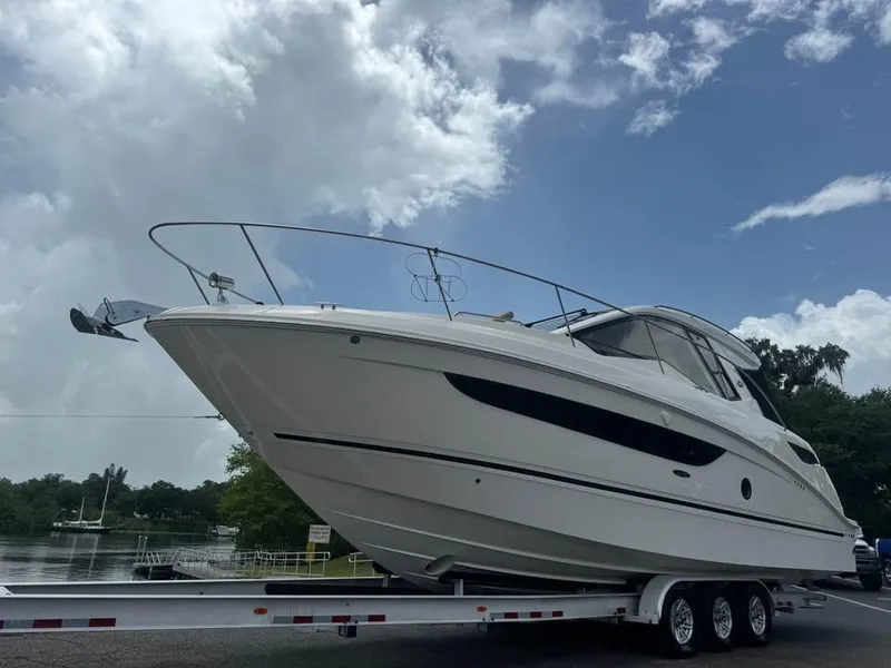 Slide: The Image of 2017 Sea Ray Sundancer 350 Coupe on trailer under cloudy sky. - 3