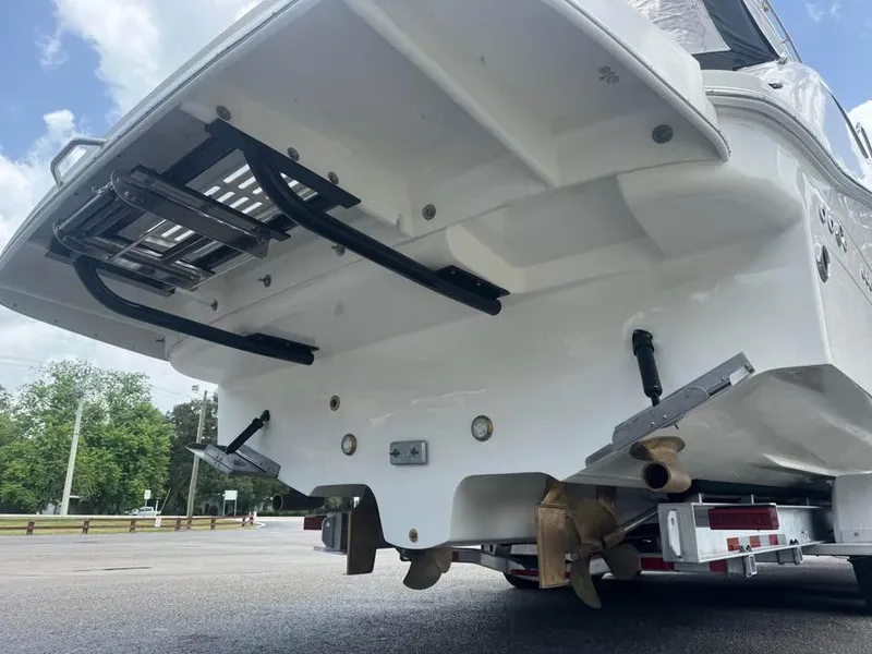 Slide: The Image of 2017 Sea Ray Sundancer 350 Coupe boat stern with ladder and propeller. - 6