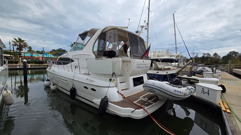 Slide: The Image of 2000 Cruisers Yachts 4450 Express Motoryacht docked in marina. - 2
