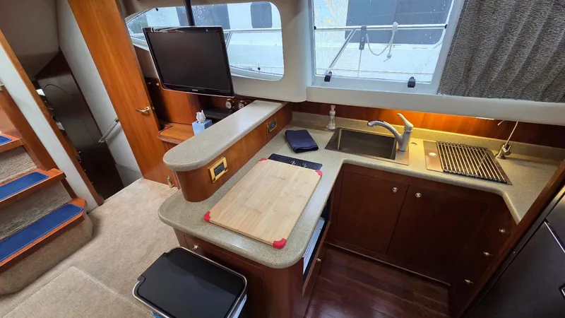 Slide: The Image of Interior of 2000 Cruisers Yachts 4450 Express Motoryacht, kitchen with wood accents. - 32