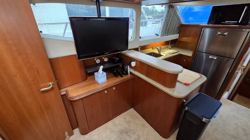 Slide: The Image of Interior of 2000 Cruisers Yachts 4450 Express Motoryacht with kitchen and TV. - 33