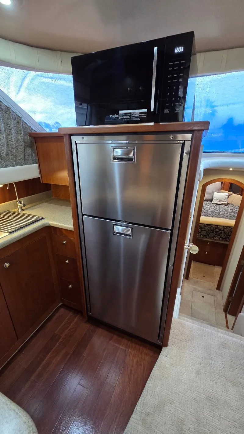 Slide: The Image of Interior of 2000 Cruisers Yachts 4450 Express Motoryacht, kitchen with microwave and fridge. - 34