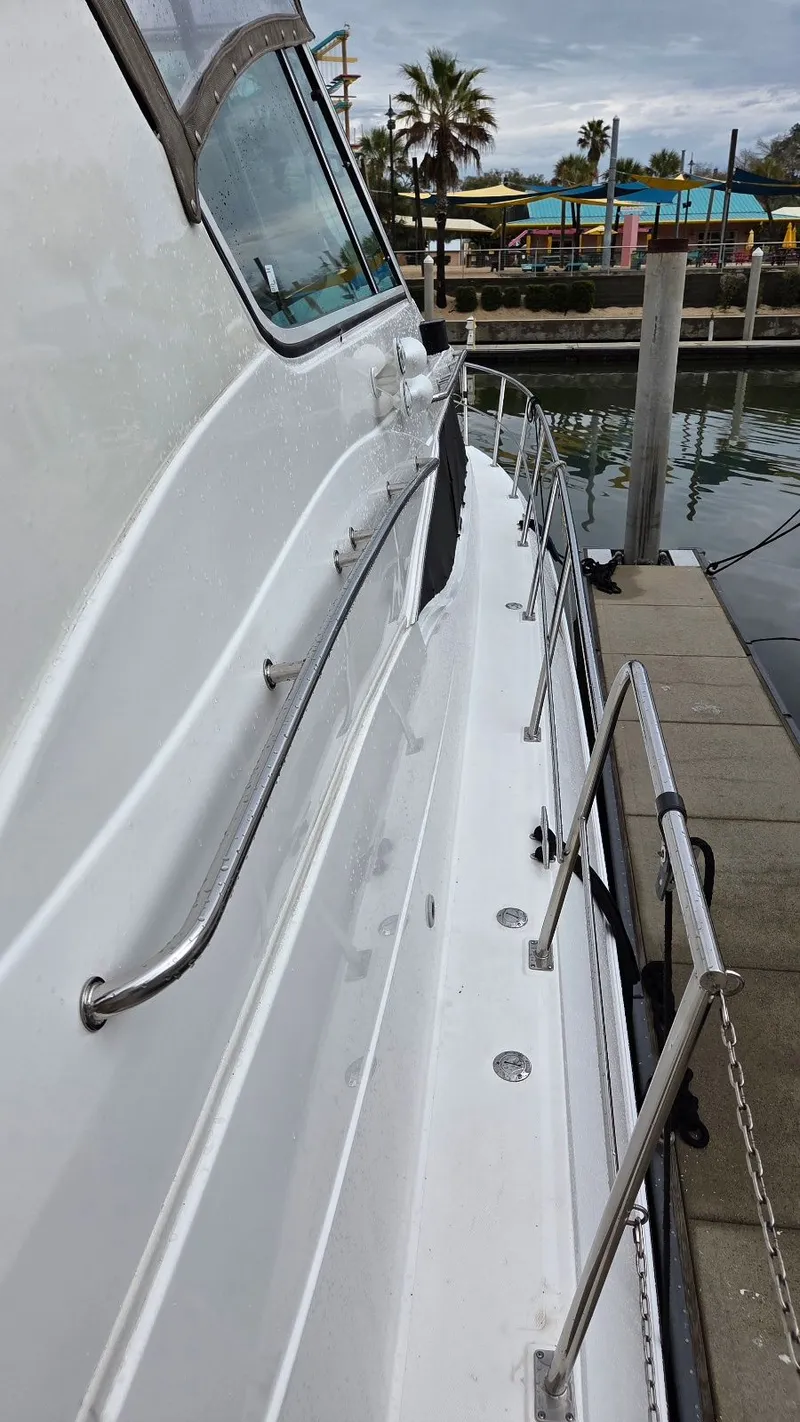 Slide: The Image of Side view of 2000 Cruisers Yachts 4450 Express Motoryacht at dock. - 7