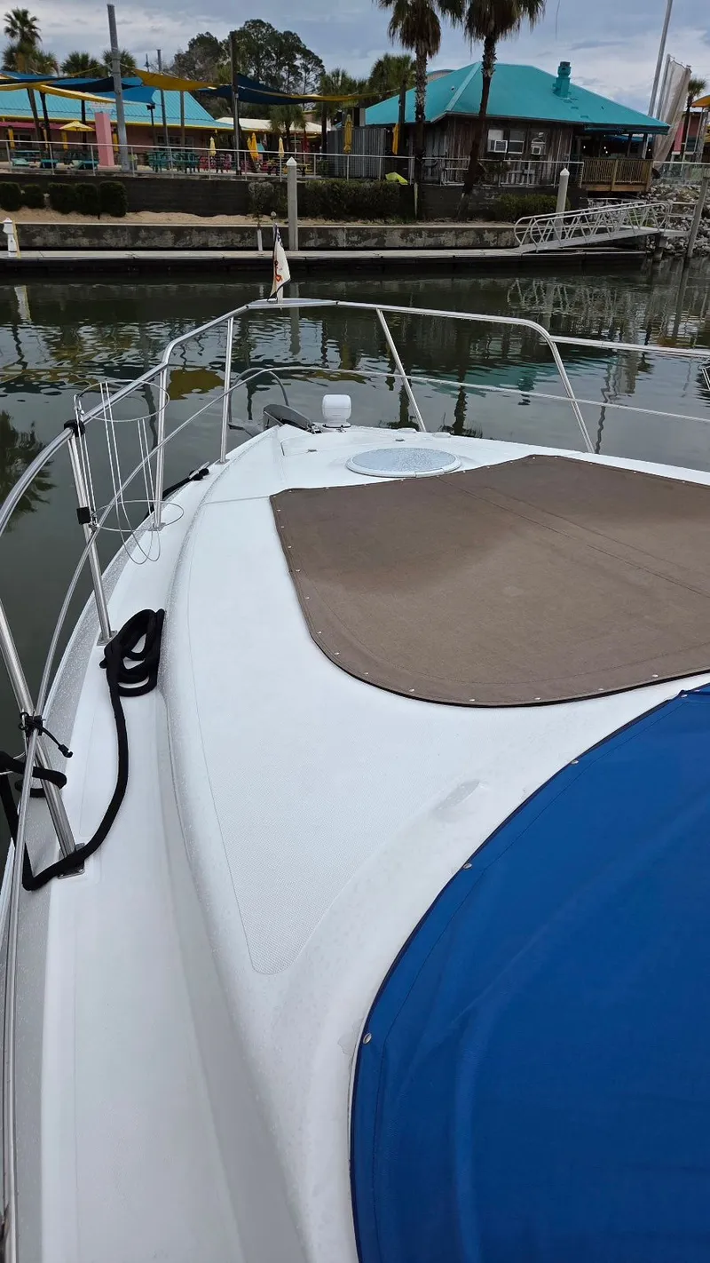 Slide: The Image of 2000 Cruisers Yachts 4450 Express Motoryacht docked, front deck view. - 9