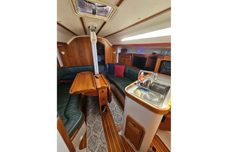 Slide: The Image of Interior of a 2000 C&C 110 sailboat with wood accents and seating area. - 18