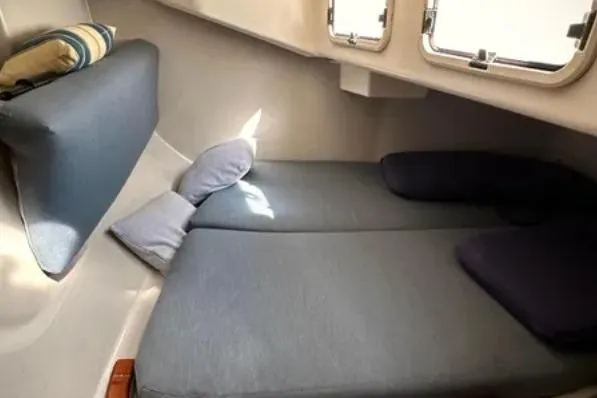 Slide: The Image of Cozy cabin interior of a 2000 C&C 110 sailboat with blue cushions and pillows. - 23