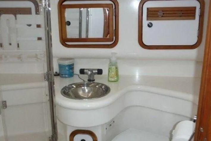 Slide: The Image of Compact yacht bathroom with sink, mirror, and storage in 2000 C&C 110 model. - 3
