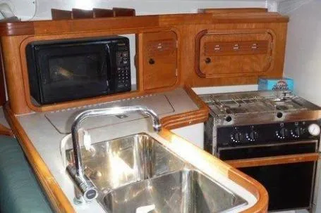 Slide: The Image of Compact kitchen in 2000 C&C 110 yacht with sink, stove, and microwave. - 4