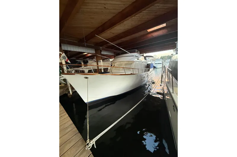 The Image of 1983 Ocean Alexander 43 Flush Aft Deck yacht docked in a covered marina. - 1