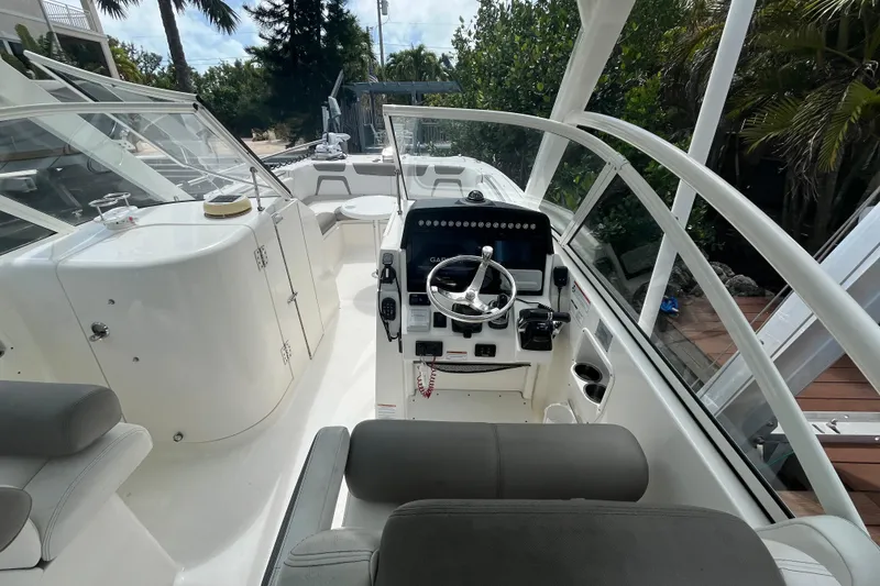 Slide: The Image of 2020 World Cat 296 DC boat interior with steering console and seating. - 12