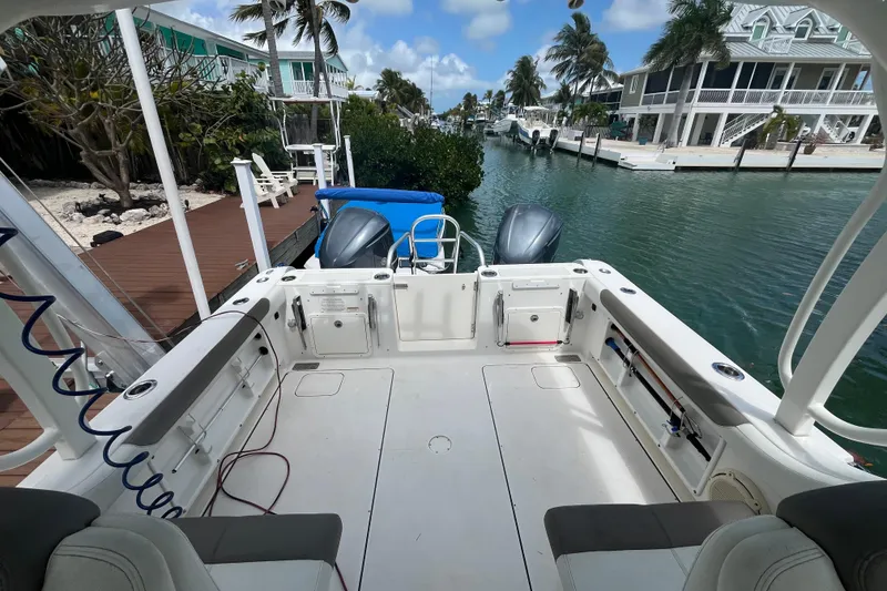 Slide: The Image of 2020 World Cat 296 DC boat docked in a scenic waterfront setting. - 16