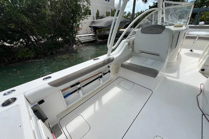 Slide: The Image of 2020 World Cat 296 DC boat interior with seating and fishing rod storage. - 18