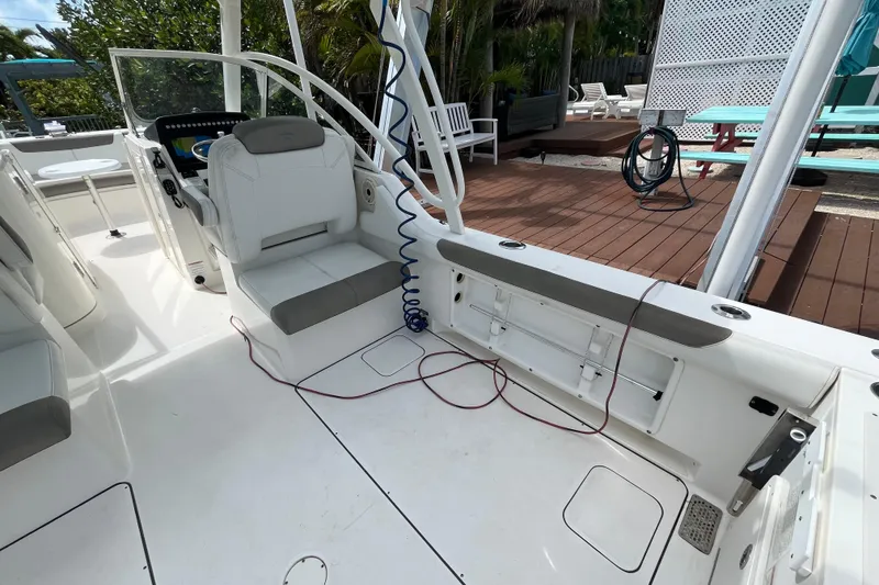 Slide: The Image of 2020 World Cat 296 DC boat interior with seating and deck view. - 19
