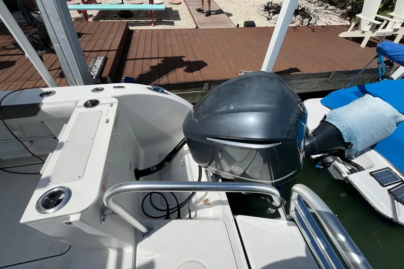 Slide: The Image of 2020 World Cat 296 DC boat with Yamaha outboard motor, docked near wooden deck. - 22