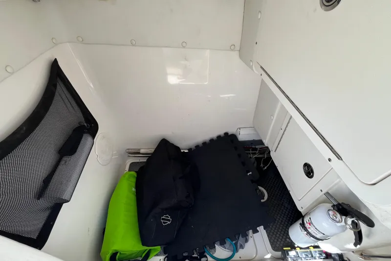 Slide: The Image of Interior storage compartment of a 2020 World Cat 296 DC boat with gear and equipment. - 23