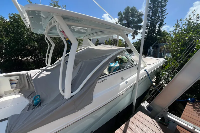 Slide: The Image of 2020 World Cat 296 DC boat docked, featuring a covered cabin and sleek design. - 6