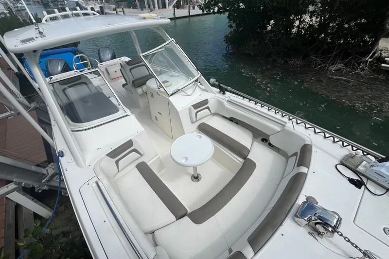 Slide: The Image of 2020 World Cat 296 DC boat with spacious seating and modern design docked by water. - 8