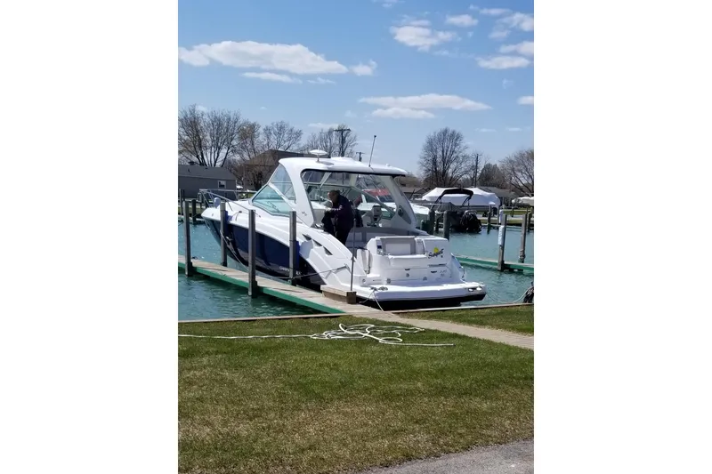 Slide: The Image of 2012 Chaparral 330 Signature boat docked on a sunny day with clear skies. - 2