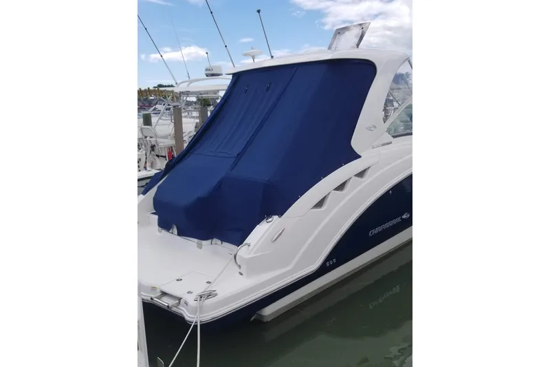 Slide: The Image of 2012 Chaparral 330 Signature boat with blue cover docked at marina. - 4