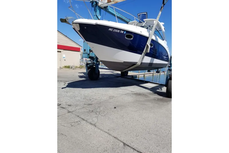 Slide: The Image of 2012 Chaparral 330 Signature boat being lifted at a marina. - 5