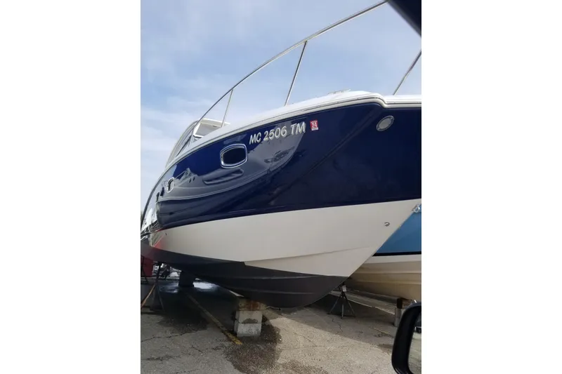 Slide: The Image of 2012 Chaparral 330 Signature boat on dry dock, blue and white hull. - 7