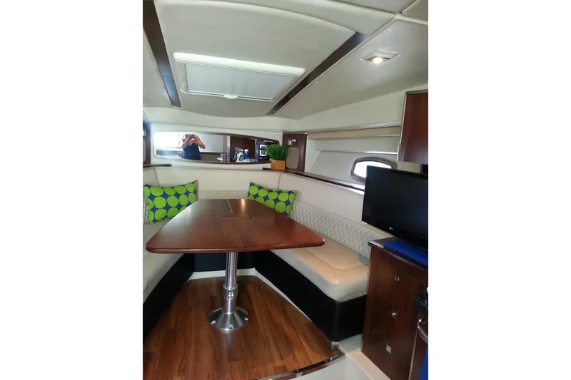 Slide: The Image of Interior of 2012 Chaparral 330 Signature yacht with dining area and modern decor. - 9