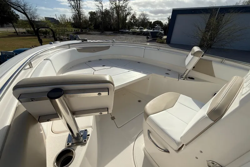 Slide: The Image of 2018 Robalo R242 Center Console boat interior with seating and storage. - 12