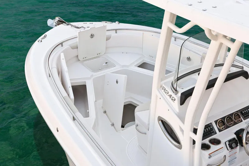Slide: The Image of 2018 Robalo R242 Center Console boat with helm and seating, outdoors under blue sky. - 6