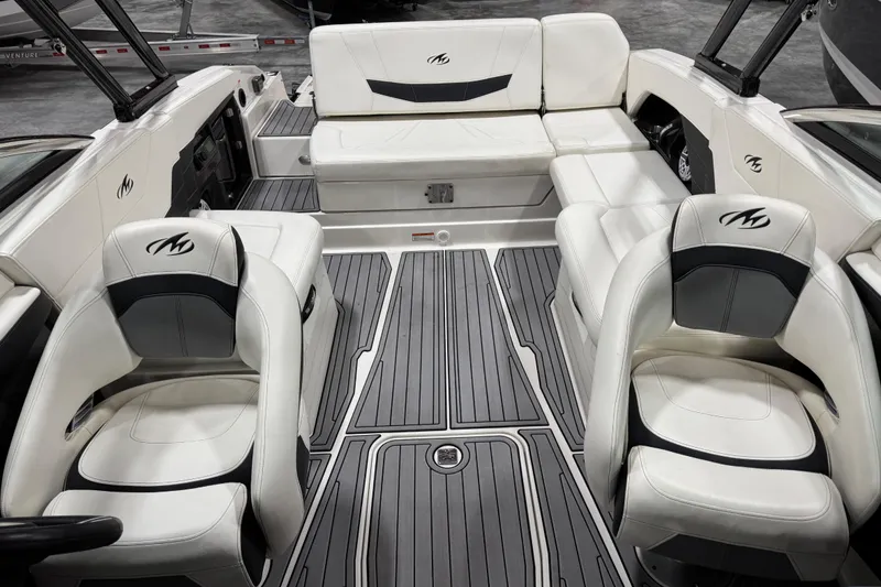 Slide: The Image of Interior of a 2014 Monterey 268SS Super Sport boat with white seating and gray flooring. - 11