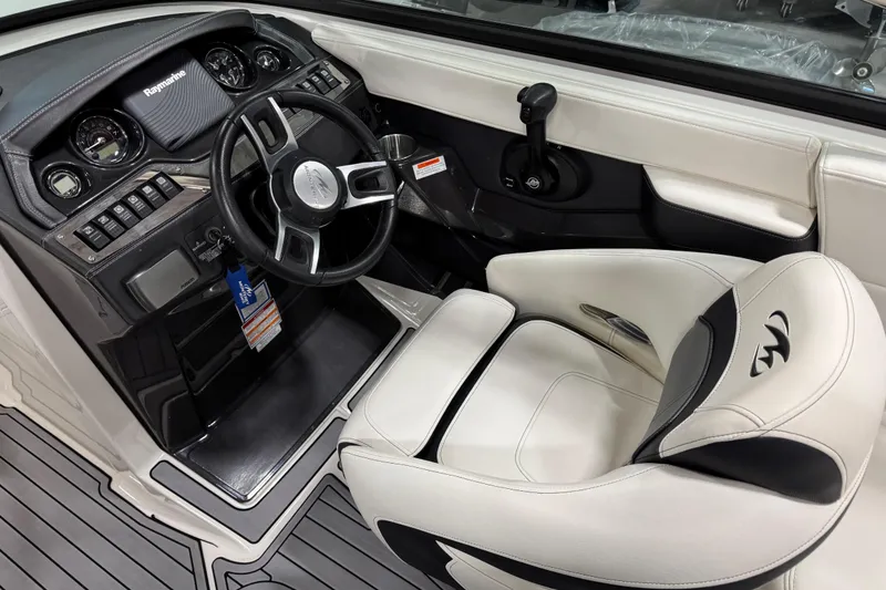 Slide: The Image of Interior of a 2014 Monterey 268SS Super Sport boat, featuring steering wheel and controls. - 13