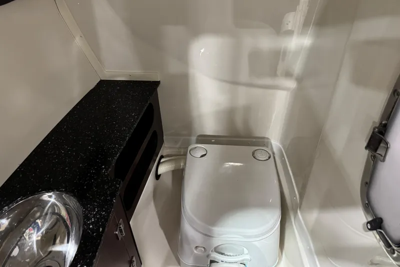Slide: The Image of 2014 Monterey 268SS Super Sport boat bathroom with compact toilet and sink. - 9