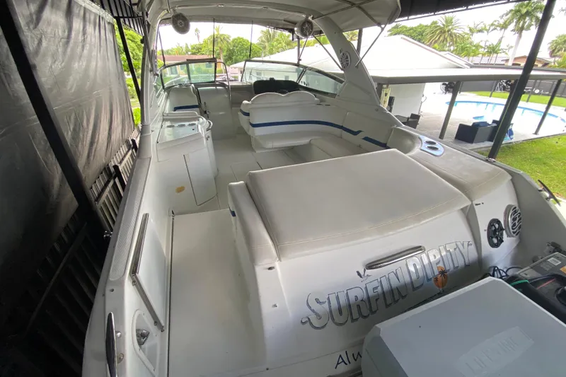 Slide: The Image of 2005 Formula 330 Sun Sport boat interior with white seating and outdoor view. - 17
