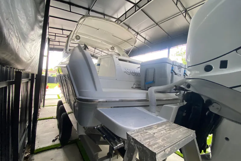 Slide: The Image of 2005 Formula 330 Sun Sport boat in covered storage, rear view with outboard motor. - 24