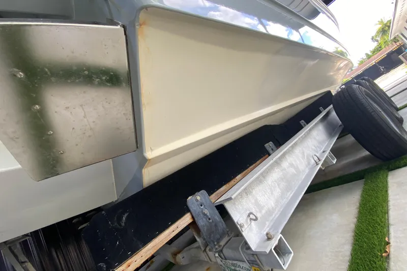Slide: The Image of 2005 Formula 330 Sun Sport boat on trailer, close-up view of hull and trailer components. - 34