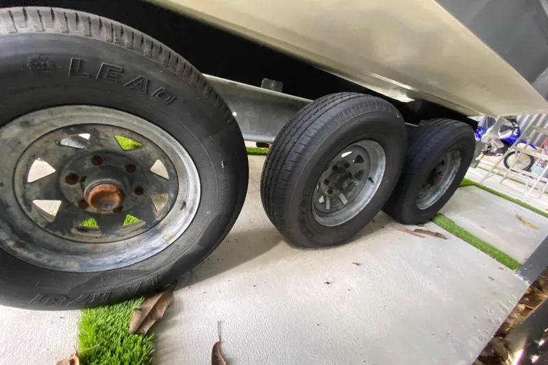 Slide: The Image of Trailer wheels of a 2005 Formula 330 Sun Sport boat on concrete. - 35