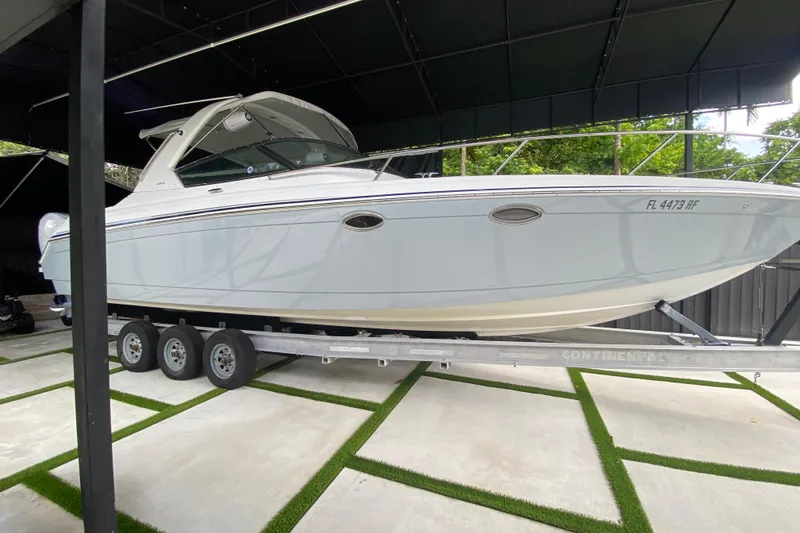 Slide: The Image of 2005 Formula 330 Sun Sport boat on trailer in covered storage area. - 4