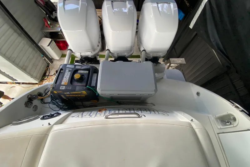 Slide: The Image of 2005 Formula 330 Sun Sport boat with triple outboard engines and equipment on deck. - 40