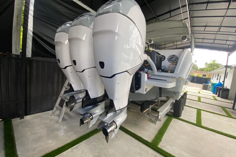 Slide: The Image of 2005 Formula 330 Sun Sport boat with four powerful outboard engines in a covered area. - 41