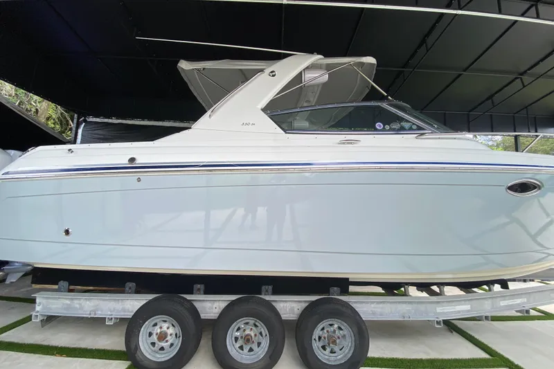 Slide: The Image of 2005 Formula 330 Sun Sport boat on a trailer in a covered area. - 8