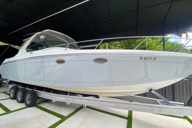 Slide: The Image of 2005 Formula 330 Sun Sport boat on trailer, under a canopy. - 9