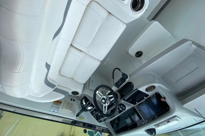 Slide: The Image of 2009 Formula 330 Sun Sport boat interior with white seating and modern dashboard controls. - 17