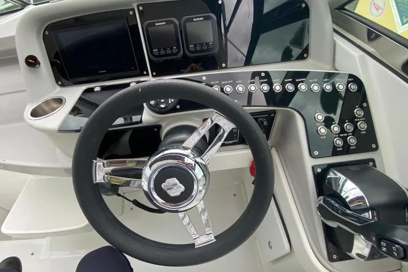 Slide: The Image of Cockpit of 2009 Formula 330 Sun Sport with steering wheel and control panel. - 19